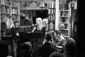 a black and white image of Stranger Still performing in a bookstore
