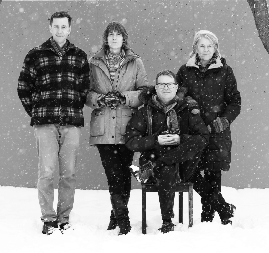 The four members of Stranger Still, posed outdoors in winter.